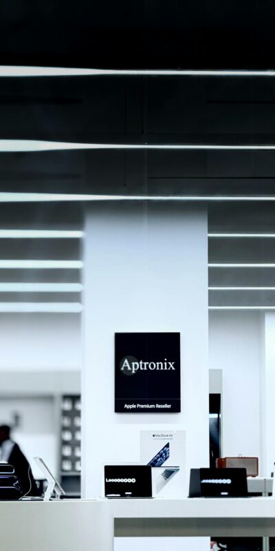 Sleek modern store interior featuring Aptronix branding and technology displays.